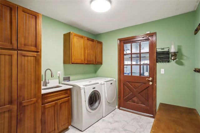 laundry area with cabinets, sink, and washing machine and clothes dryer