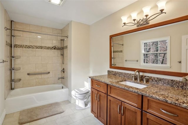 full bathroom featuring vanity, tiled shower / bath combo, toilet, and tile patterned flooring