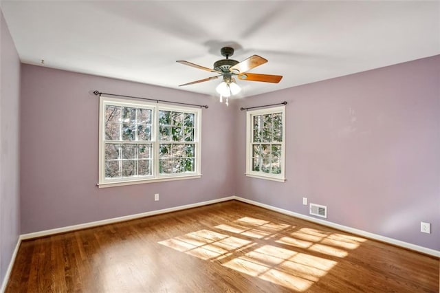 unfurnished room with ceiling fan and wood-type flooring