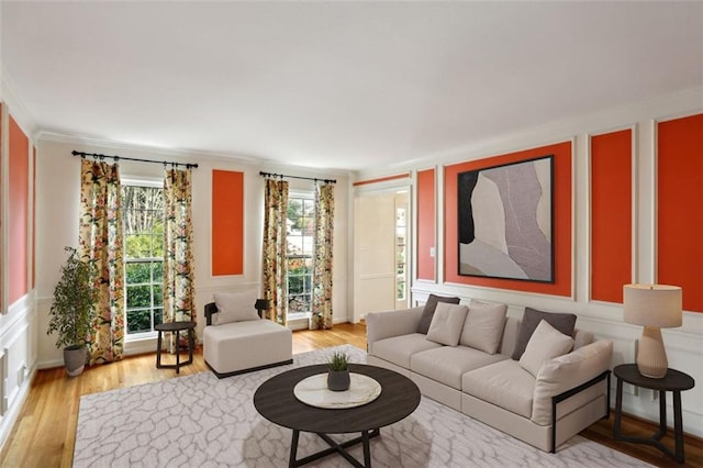 living room with hardwood / wood-style floors and crown molding