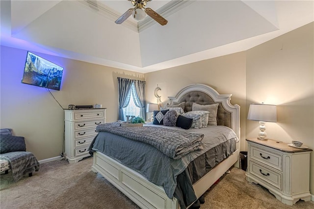 bedroom with a raised ceiling, light carpet, and ceiling fan