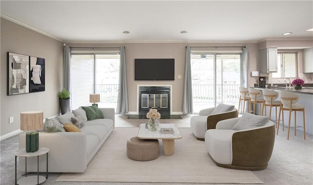 carpeted living room with a fireplace with flush hearth, a healthy amount of sunlight, ornamental molding, and baseboards