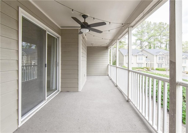 balcony with a residential view and ceiling fan