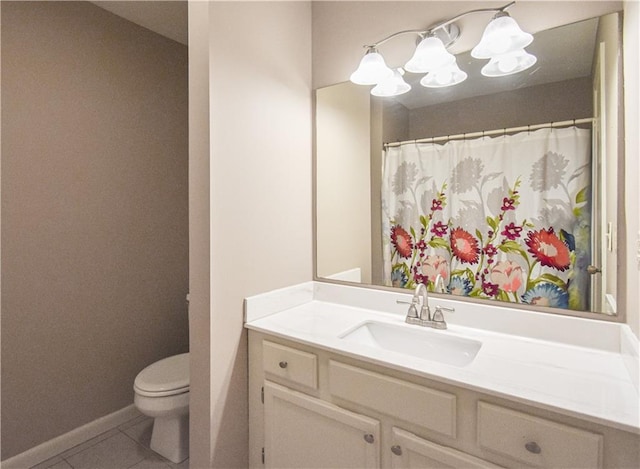 full bath featuring vanity, tile patterned flooring, toilet, and baseboards