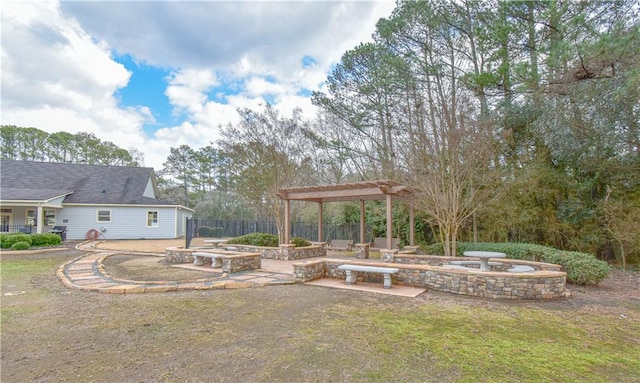 view of yard with a patio, an outdoor fire pit, fence, and a pergola