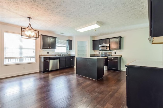 5900 Fairington Farms Ln, Stonecrest, GA 30038 - kitchen with stainless steel appliances, a chandelier, a textured ceiling, a kitchen island, and light countertops