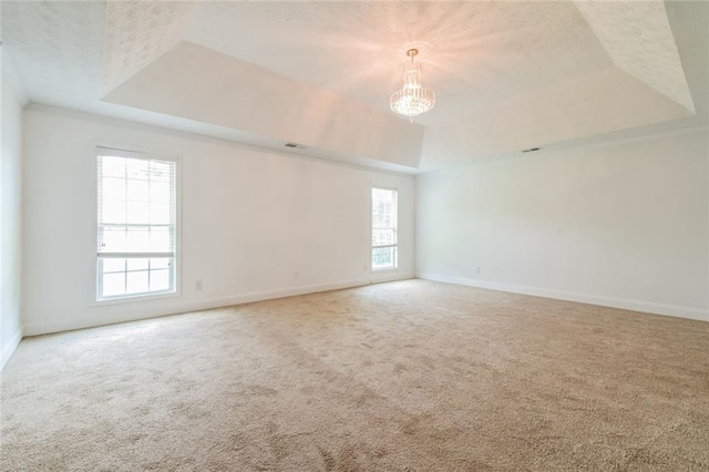 5900 Fairington Farms Ln, Stonecrest, GA 30038 - carpeted empty room featuring a tray ceiling, plenty of natural light, a chandelier, and a textured ceiling