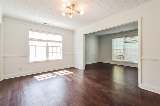 5900 Fairington Farms Ln, Stonecrest, GA 30038 - spare room with a chandelier, healthy amount of natural light, a textured ceiling, dark wood-type flooring, and ornamental molding