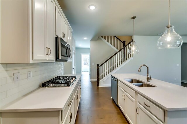 321 Principal Meridian Dr, Dallas, GA 30132 - unfurnished living room with a ceiling fan, visible vents, wood finished floors, stairway, and a fireplace with raised hearth