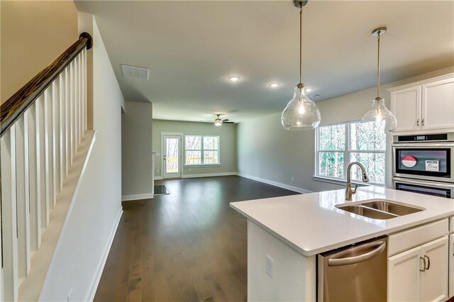 321 Principal Meridian Dr, Dallas, GA 30132 - kitchen featuring light stone countertops, a sink, light wood-style flooring, appliances with stainless steel finishes, and hanging light fixtures