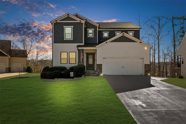 view of front of home with a garage, driveway, and a front yard