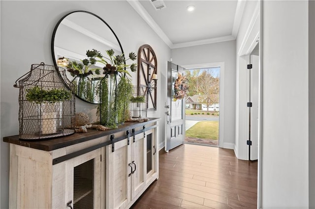 entryway with crown molding and dark hardwood / wood-style floors