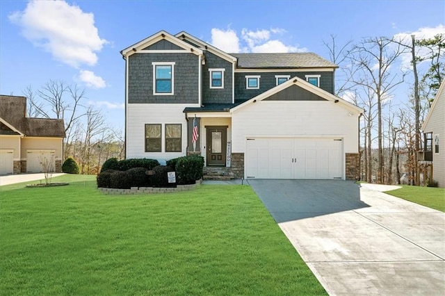 craftsman inspired home with a front yard, an attached garage, and driveway