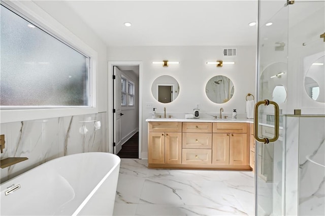 full bathroom with double vanity, visible vents, a soaking tub, marble finish floor, and a sink