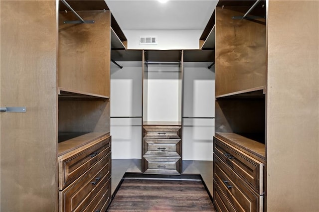 walk in closet with dark wood-type flooring and visible vents