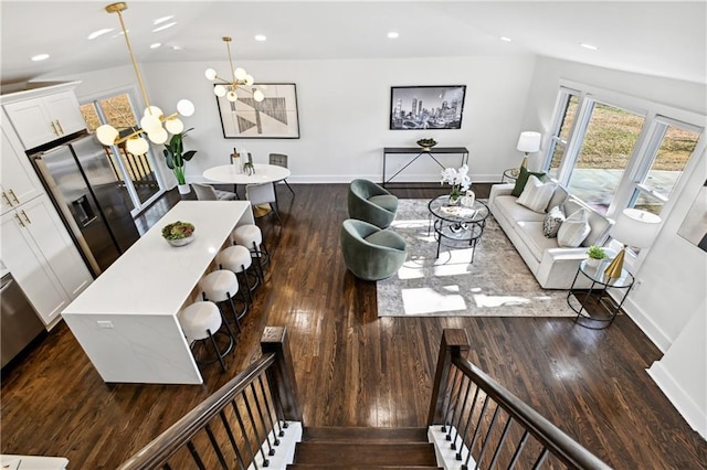 living room with dark wood-style floors, recessed lighting, a notable chandelier, and baseboards