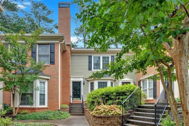 4 Mount Vernon Cir, Atlanta, GA 30338 - view of front facade featuring a chimney, brick siding, and stairs