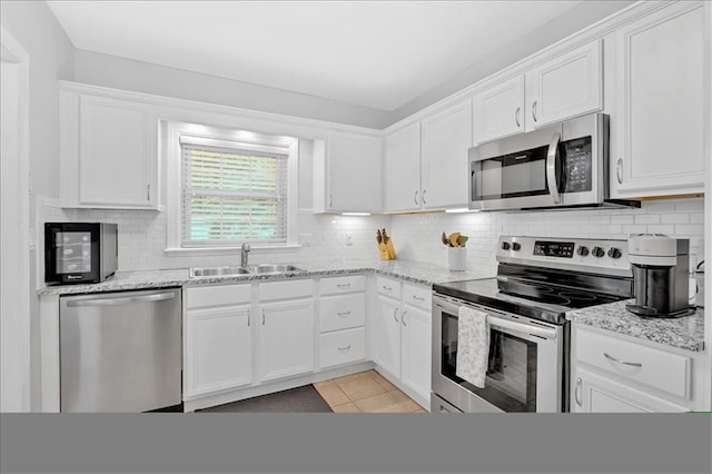 4 Mount Vernon Cir, Atlanta, GA 30338 - kitchen with appliances with stainless steel finishes, a sink, white cabinets, backsplash, and light stone countertops