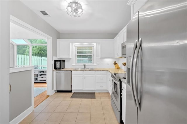 4 Mount Vernon Cir, Atlanta, GA 30338 - kitchen with stainless steel appliances, a sink, white cabinets, and plenty of natural light