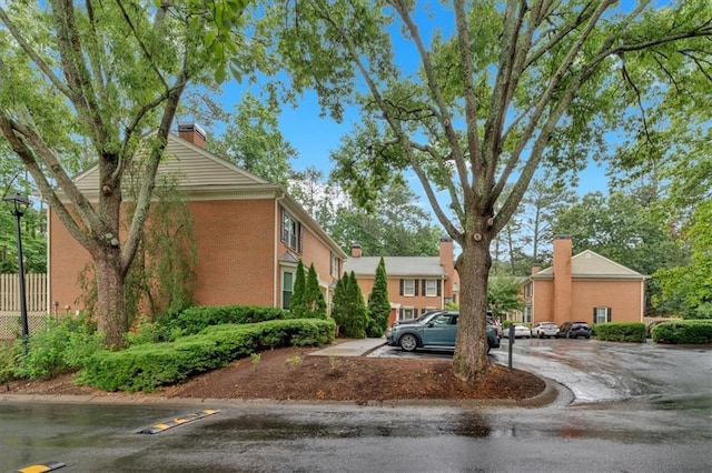 4 Mount Vernon Cir, Atlanta, GA 30338 - view of front of home with uncovered parking, a chimney, and brick siding