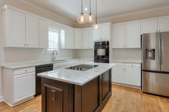 kitchen with black appliances, white cabinetry, ornamental molding, and a sink