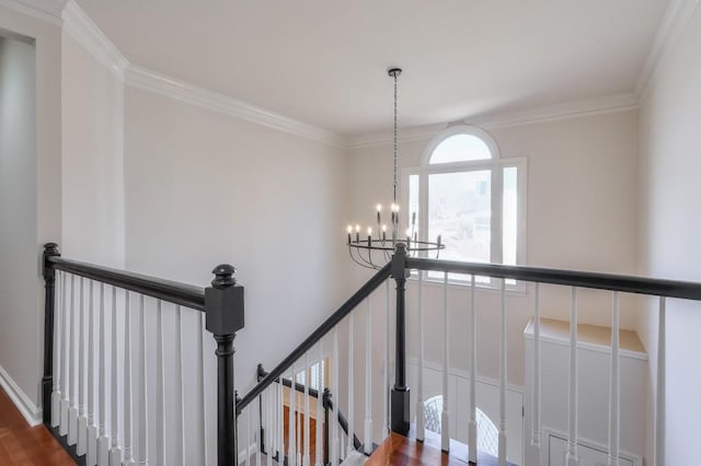 stairs with crown molding and a notable chandelier