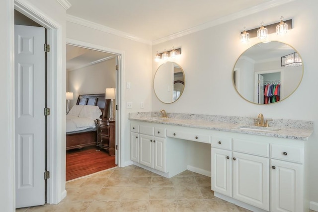 ensuite bathroom with ensuite bathroom, tile patterned flooring, a sink, and crown molding