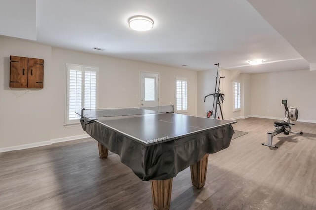 recreation room featuring dark wood-type flooring, visible vents, and baseboards