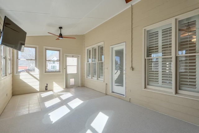 unfurnished sunroom featuring vaulted ceiling and ceiling fan