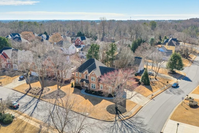 drone / aerial view featuring a forest view and a residential view