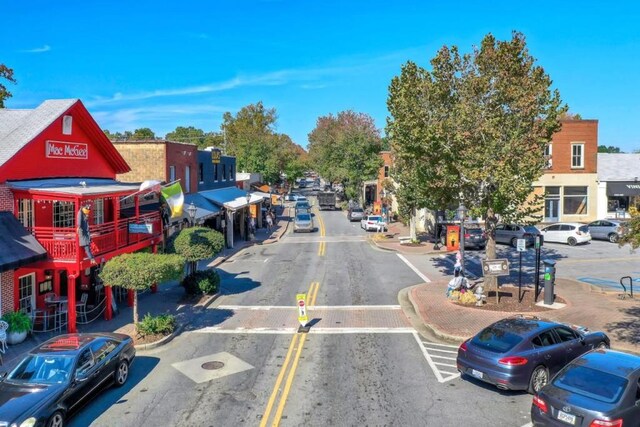 view of street with curbs, sidewalks, and street lights