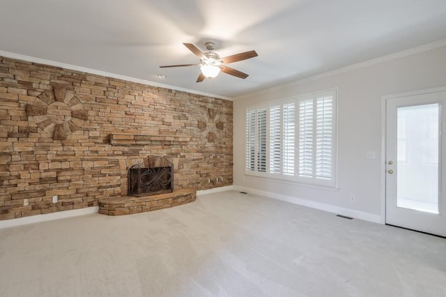 unfurnished living room featuring carpet floors, a fireplace, visible vents, and crown molding