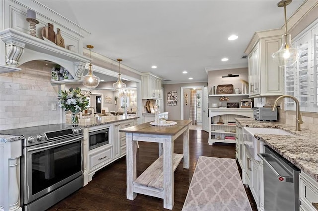 kitchen with light stone counters, backsplash, stainless steel appliances, and hanging light fixtures