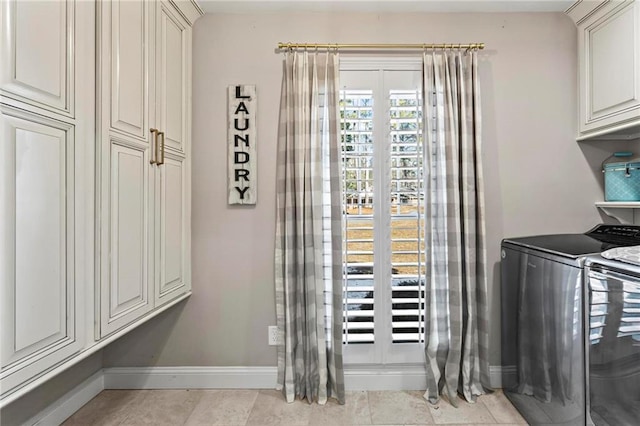 clothes washing area featuring cabinets, independent washer and dryer, and light tile patterned flooring