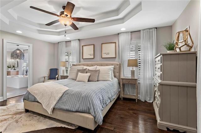 bedroom featuring a raised ceiling, ceiling fan, dark hardwood / wood-style flooring, and sink