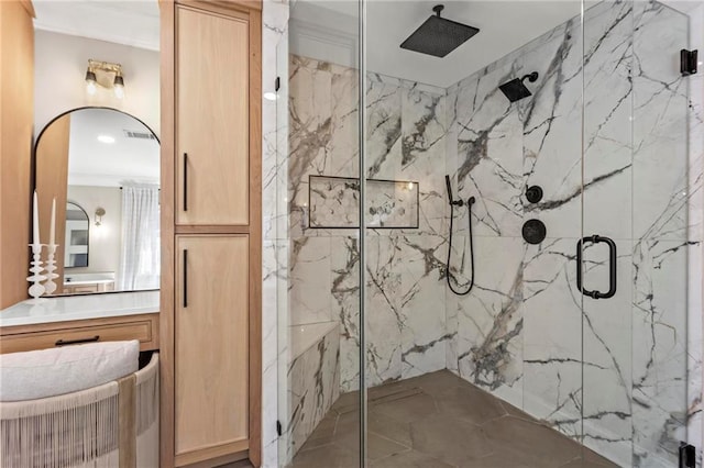 bathroom featuring vanity, ornamental molding, and an enclosed shower