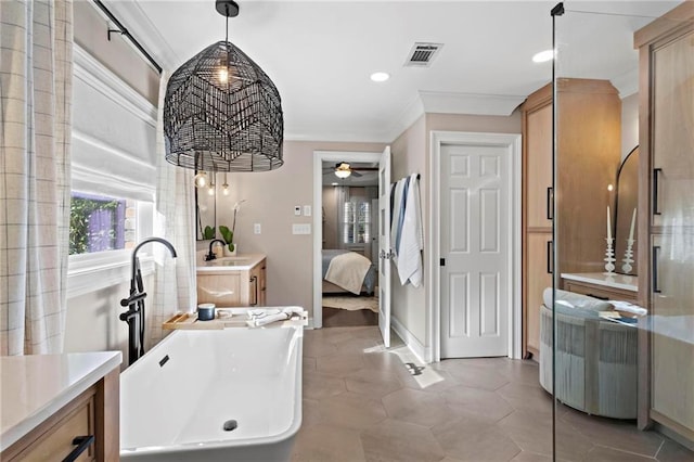 bathroom with ceiling fan, a bathtub, tile patterned flooring, ornamental molding, and vanity