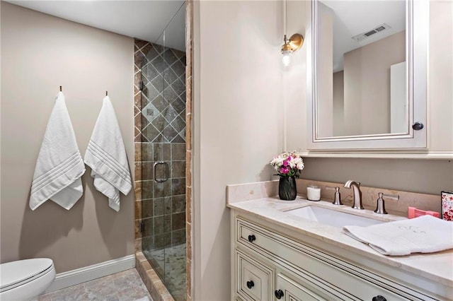 bathroom featuring an enclosed shower, vanity, and toilet