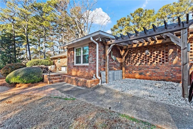 view of front of house featuring a pergola and a patio area