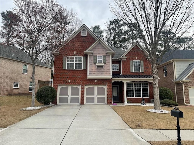 view of front of home with concrete driveway, an attached garage, brick siding, and a front yard