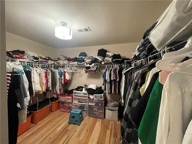 walk in closet featuring wood finished floors and visible vents