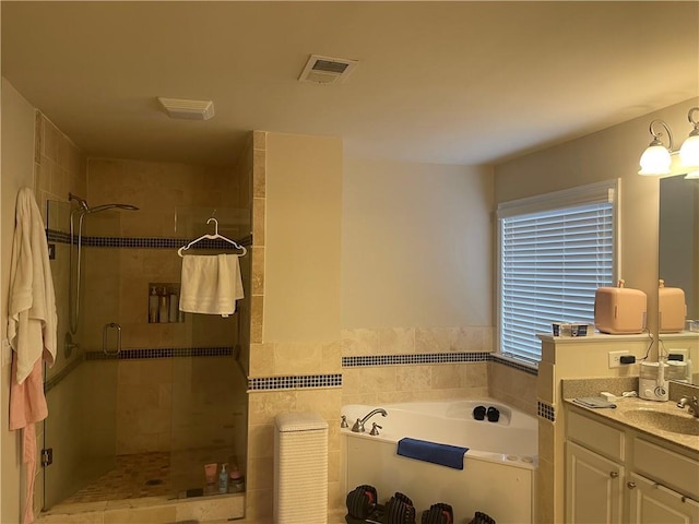 full bathroom featuring a bath, visible vents, a shower stall, and vanity