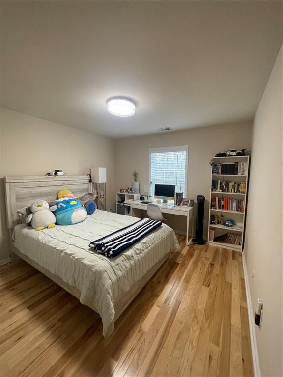 bedroom with light wood-style floors and baseboards