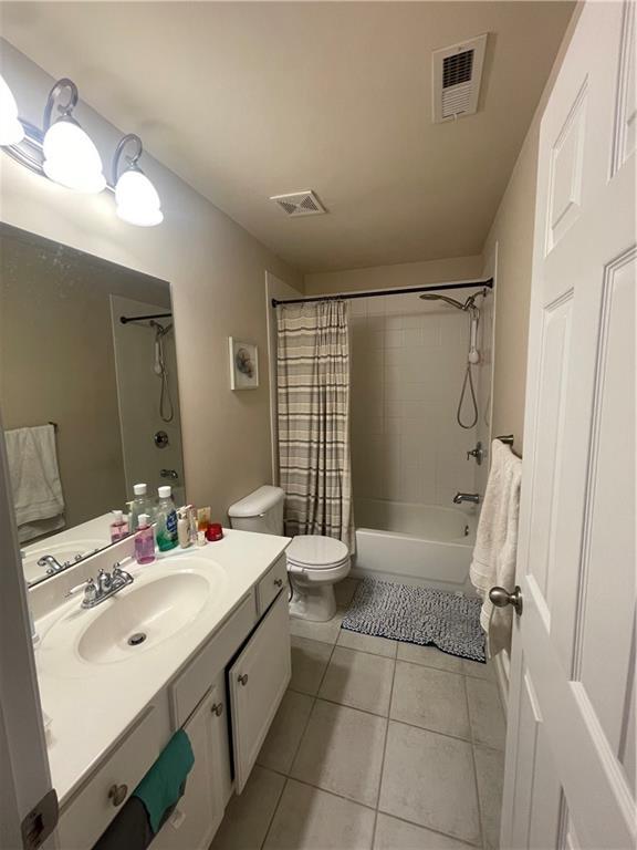 bathroom featuring vanity, tile patterned floors, toilet, and visible vents