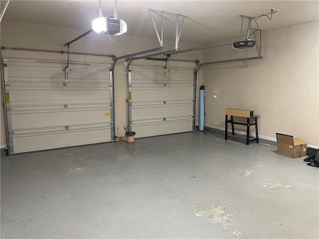 garage featuring a garage door opener and baseboards