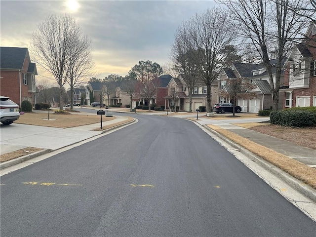 view of street with sidewalks, curbs, and a residential view