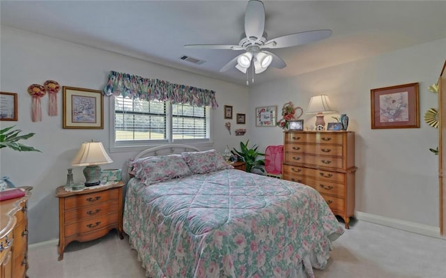 bedroom featuring a ceiling fan, baseboards, light colored carpet, and visible vents