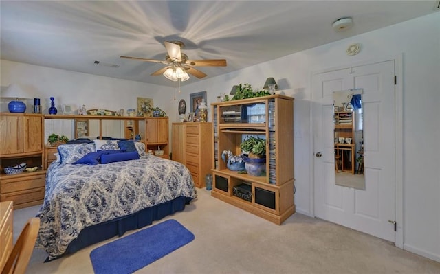 bedroom featuring light carpet, visible vents, and ceiling fan