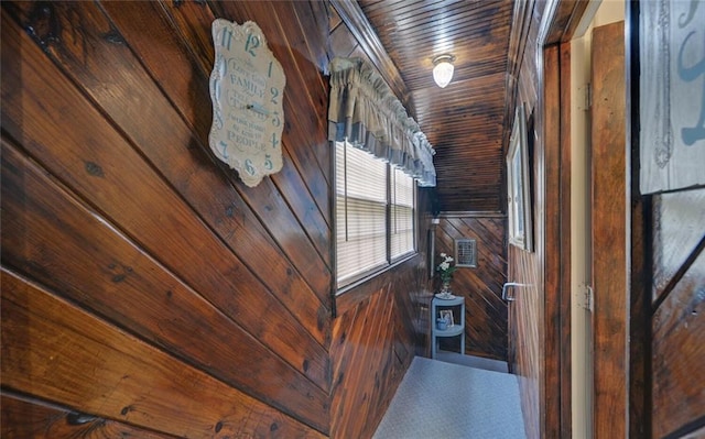 interior space featuring wooden walls and wooden ceiling