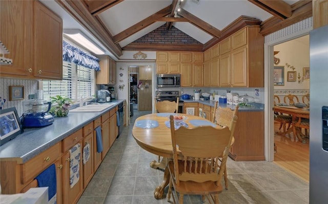 kitchen with a sink, vaulted ceiling with beams, tasteful backsplash, light tile patterned floors, and stainless steel appliances